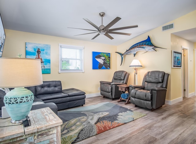 living room with ceiling fan and light hardwood / wood-style flooring