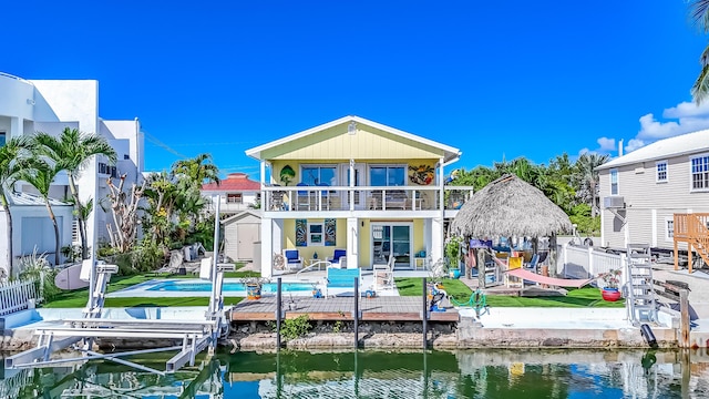 back of property featuring a gazebo, a patio, a balcony, and a water view