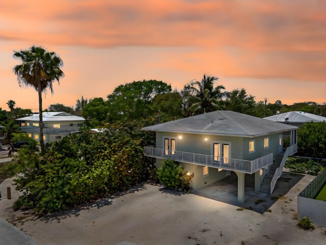 973 Gibraltar Rd, Key Largo, FL 33037 - view of front of home with french doors, stairway, and a carport