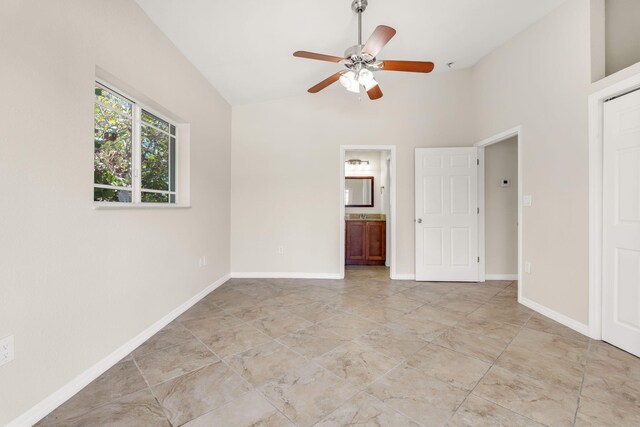 973 Gibraltar Rd, Key Largo, FL 33037 - unfurnished bedroom featuring high vaulted ceiling, connected bathroom, baseboards, and a ceiling fan