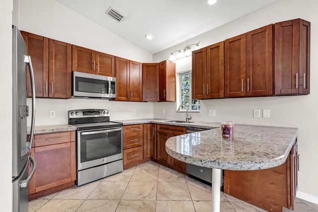 973 Gibraltar Rd, Key Largo, FL 33037 - kitchen with stainless steel appliances, a sink, a peninsula, vaulted ceiling, and light stone counters