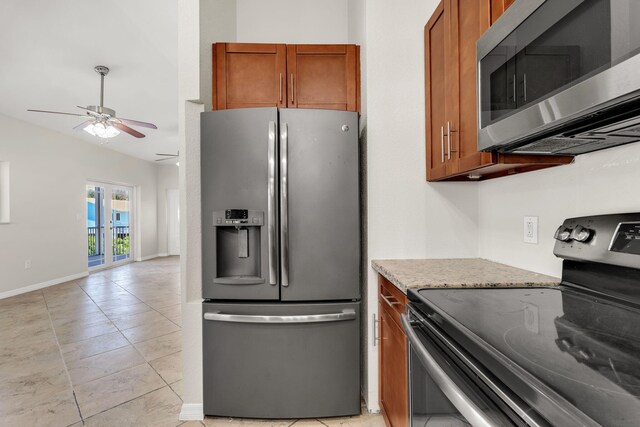 973 Gibraltar Rd, Key Largo, FL 33037 - kitchen featuring appliances with stainless steel finishes, ceiling fan, brown cabinets, and light tile patterned floors