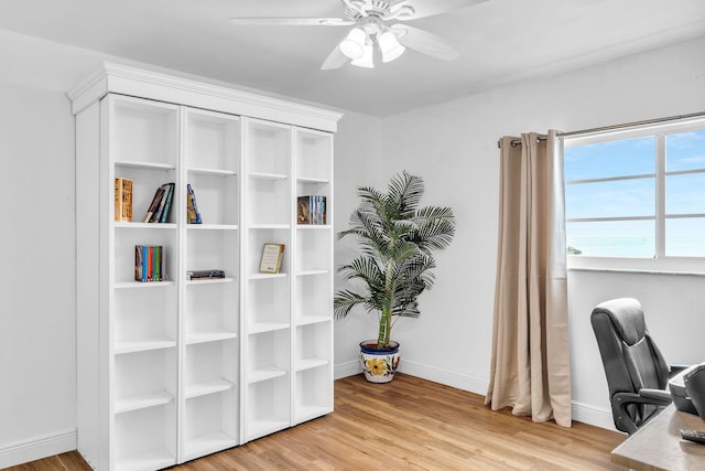 home office featuring wood-type flooring and ceiling fan