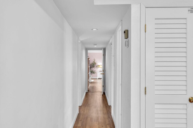 hall with hardwood / wood-style floors