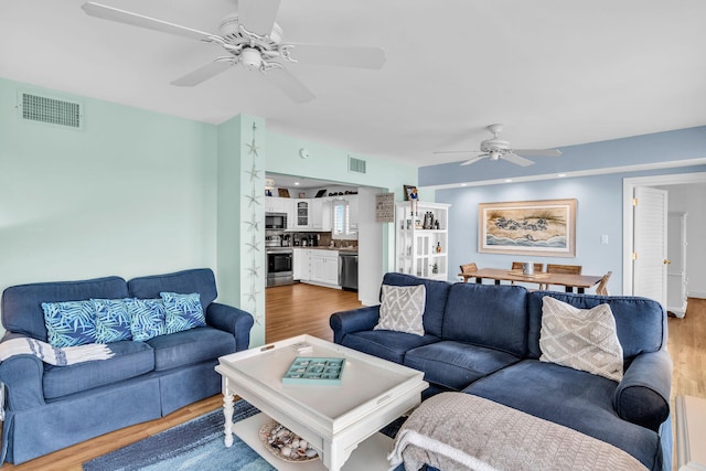 living room with hardwood / wood-style floors and ceiling fan