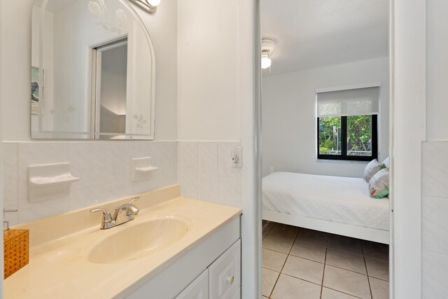 bathroom with vanity, tile walls, and tile patterned floors