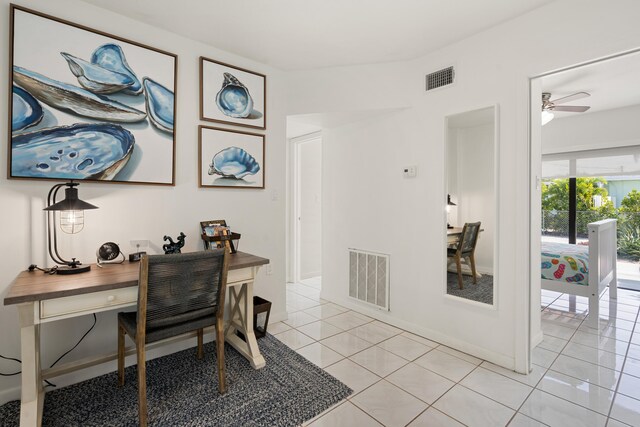 tiled home office featuring ceiling fan