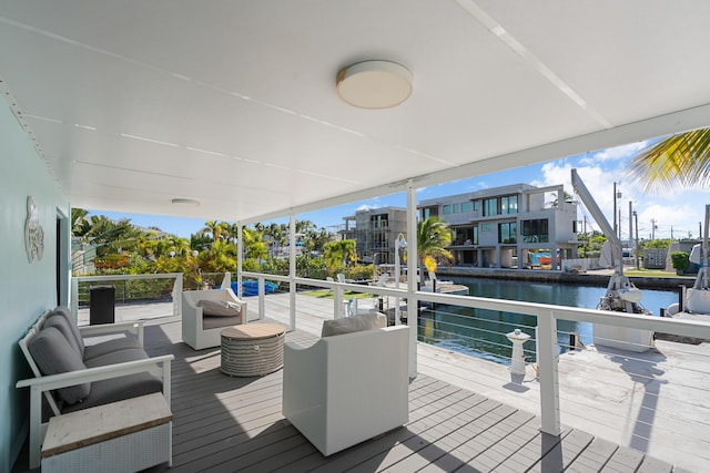 deck with a water view and an outdoor hangout area