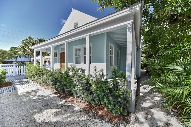 view of side of home with a porch