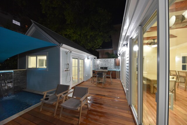 deck at night featuring french doors