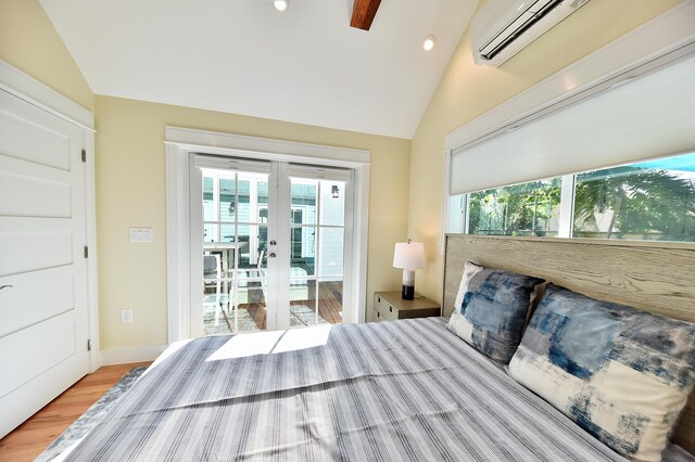 bedroom with multiple windows, lofted ceiling, access to outside, and light wood-type flooring