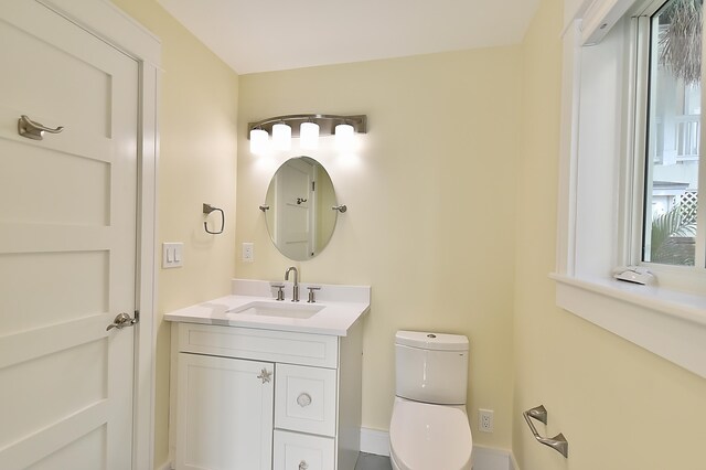 bathroom featuring vanity and toilet