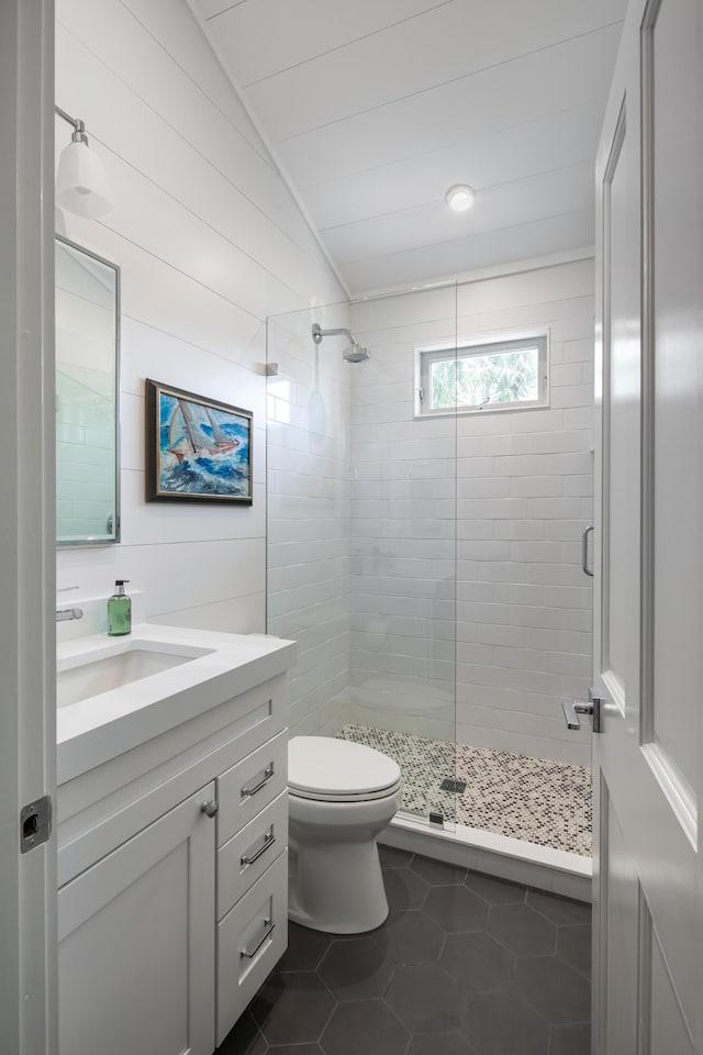 full bath with vaulted ceiling, a shower stall, toilet, and tile patterned floors