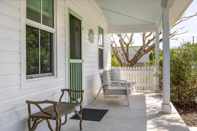 view of patio / terrace with a porch and fence