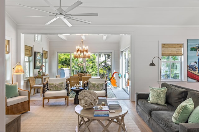 sunroom / solarium with plenty of natural light and an inviting chandelier