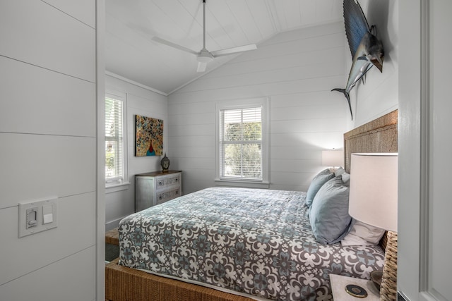 bedroom with lofted ceiling and multiple windows