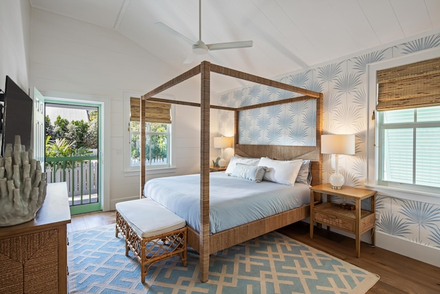 bedroom with lofted ceiling, wallpapered walls, access to outside, and wood finished floors