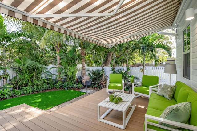 deck featuring a fenced backyard and an outdoor living space