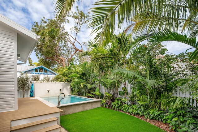 view of yard with fence and a fenced in pool