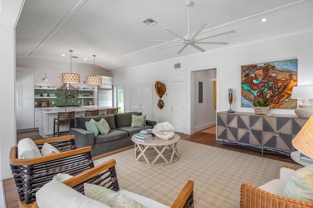 living area with lofted ceiling, light wood finished floors, visible vents, and recessed lighting