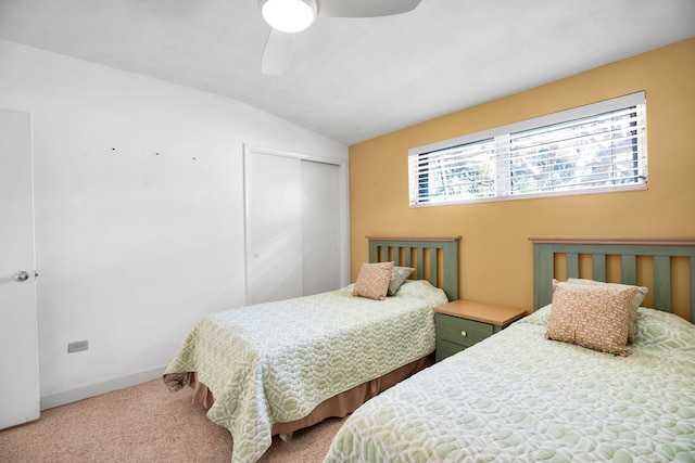 bedroom featuring vaulted ceiling, carpet flooring, ceiling fan, and a closet