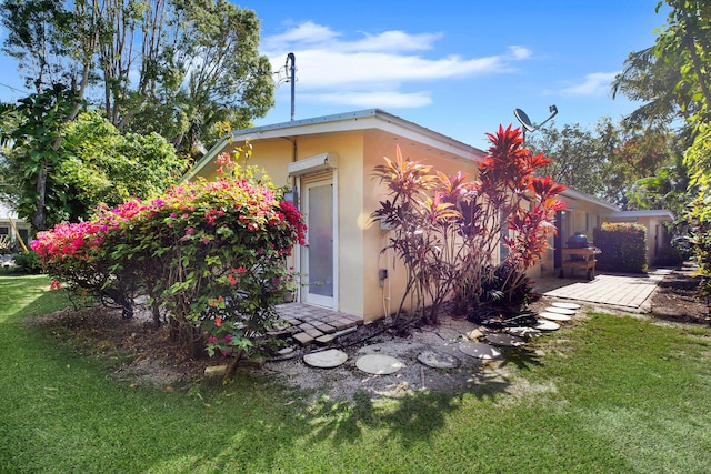 view of side of home featuring a lawn