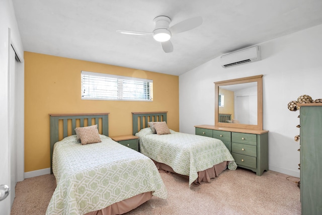 carpeted bedroom with a wall mounted air conditioner, ceiling fan, and a closet