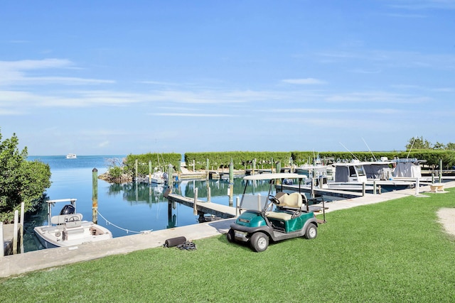 view of dock with a yard and a water view