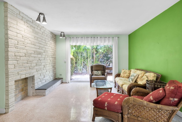 living room with a stone fireplace