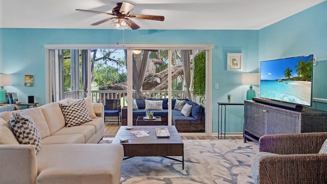 living room with ceiling fan and light hardwood / wood-style floors