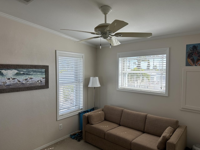 carpeted living room featuring crown molding, ceiling fan, and a wealth of natural light