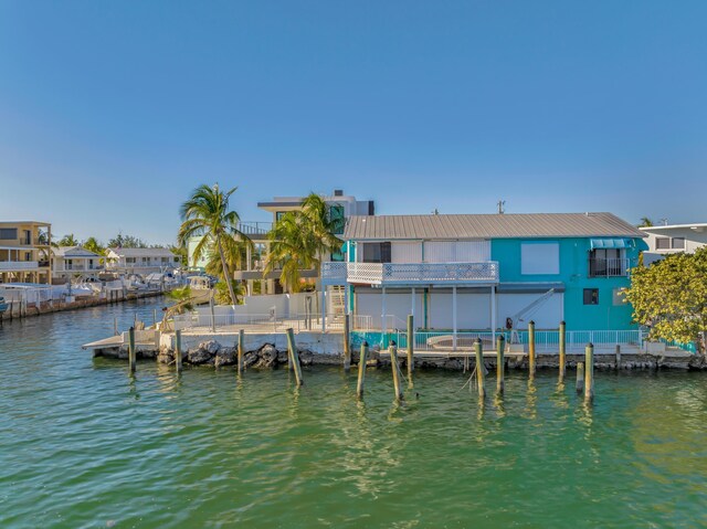 view of dock featuring a balcony and a water view