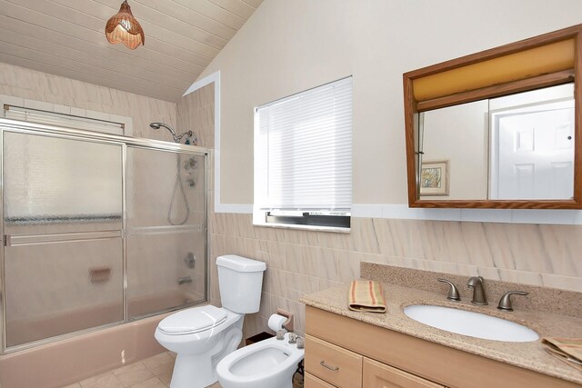 full bathroom with lofted ceiling, tile patterned floors, toilet, combined bath / shower with glass door, and tile walls