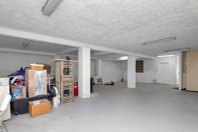 basement featuring a textured ceiling