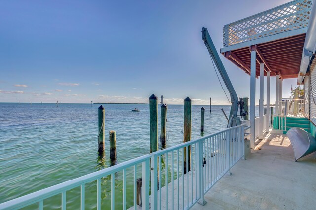 balcony with a dock and a water view