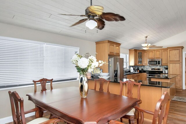 dining area with lofted ceiling, sink, ceiling fan, light hardwood / wood-style floors, and wooden ceiling