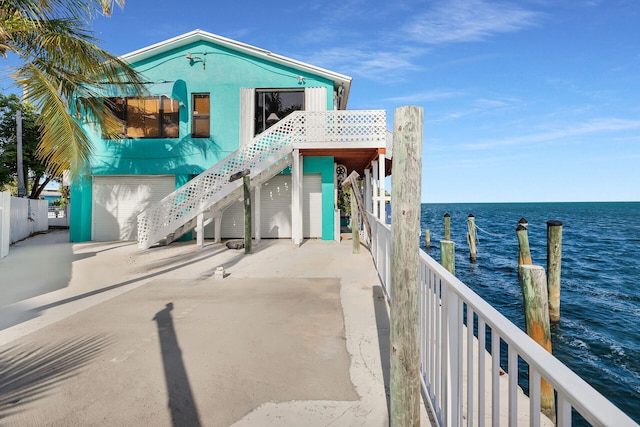 view of front facade with a garage and a water view