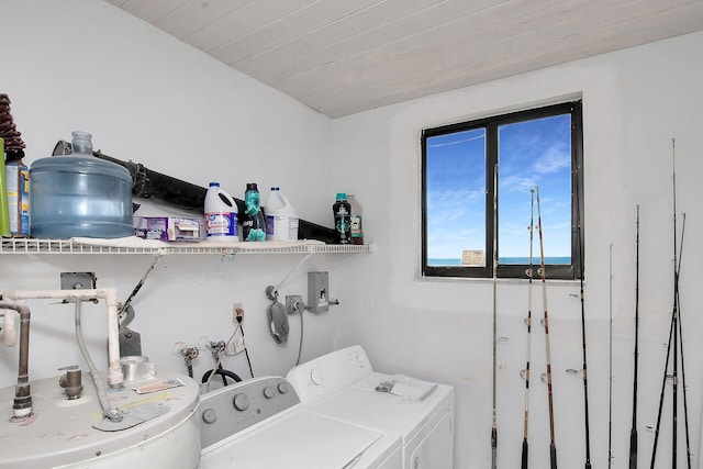 washroom featuring washing machine and dryer and wooden ceiling