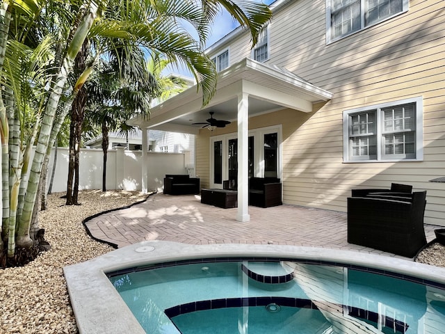 view of swimming pool featuring ceiling fan, outdoor lounge area, and a patio area