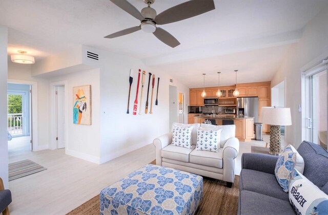 121 Lisbon Ct, Islamorada, FL 33036 - living room with light wood-type flooring, visible vents, a ceiling fan, lofted ceiling with beams, and baseboards