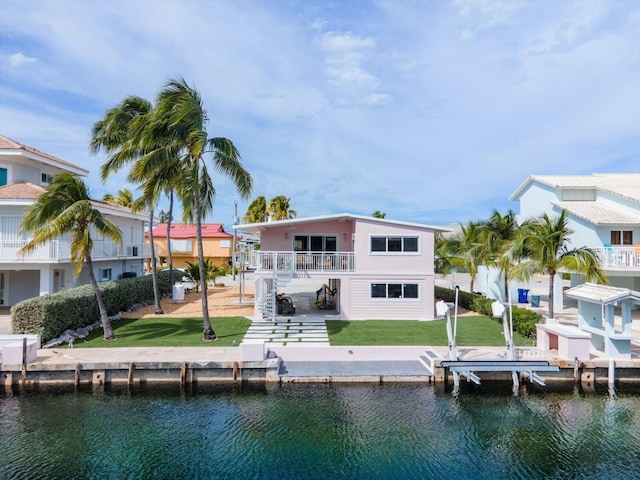 121 Lisbon Ct, Islamorada, FL 33036 - rear view of property with a water view, stairway, stucco siding, a yard, and a patio