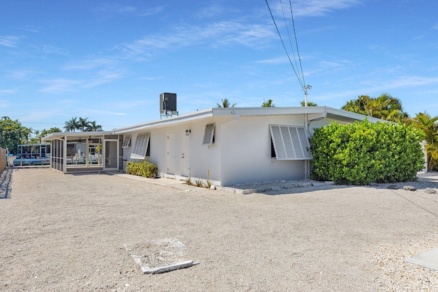 view of front of house featuring stucco siding and central air condition unit