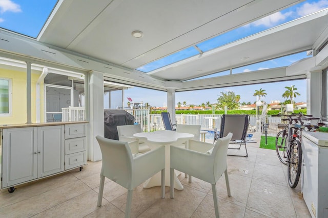 sunroom / solarium featuring lofted ceiling