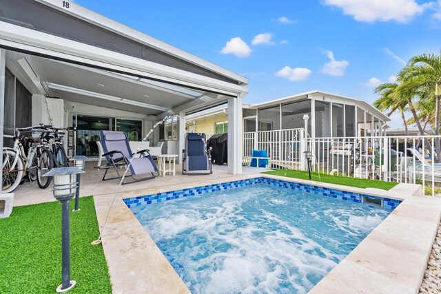 view of swimming pool with a yard, a sunroom, and a patio