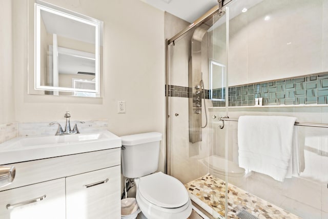 bathroom with vanity, toilet, and an enclosed shower