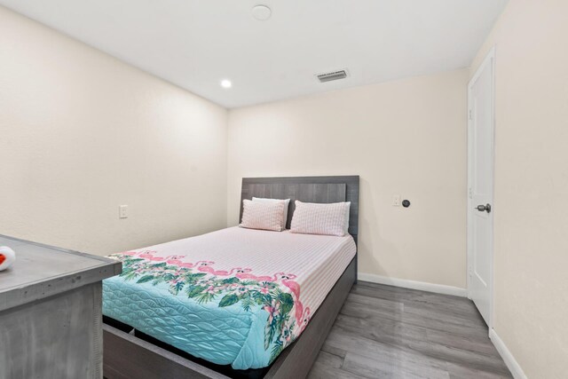 bedroom with wood-type flooring