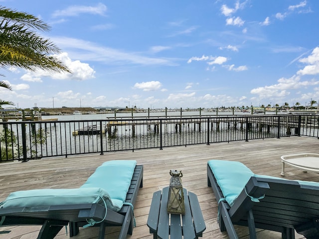 wooden terrace featuring a water view