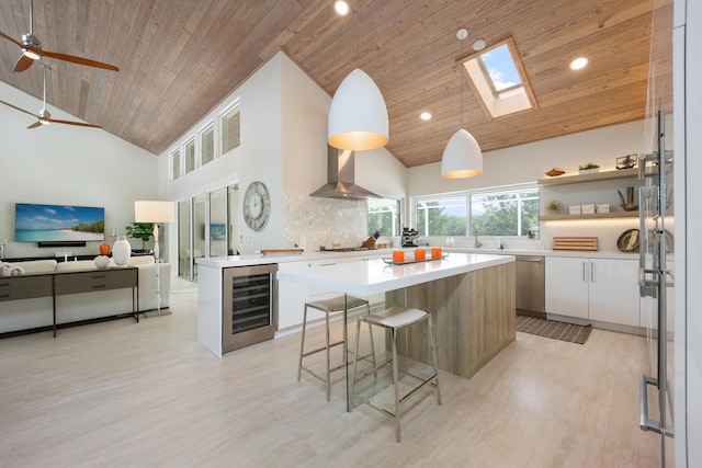 10 Mahogany Ln, Key Largo, FL 33037 - kitchen featuring beverage cooler, wooden ceiling, high vaulted ceiling, a skylight, and a breakfast bar area