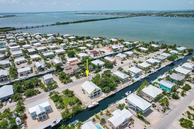 birds eye view of property with a water view and a residential view