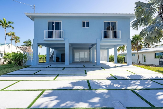 back of house with a carport and a balcony